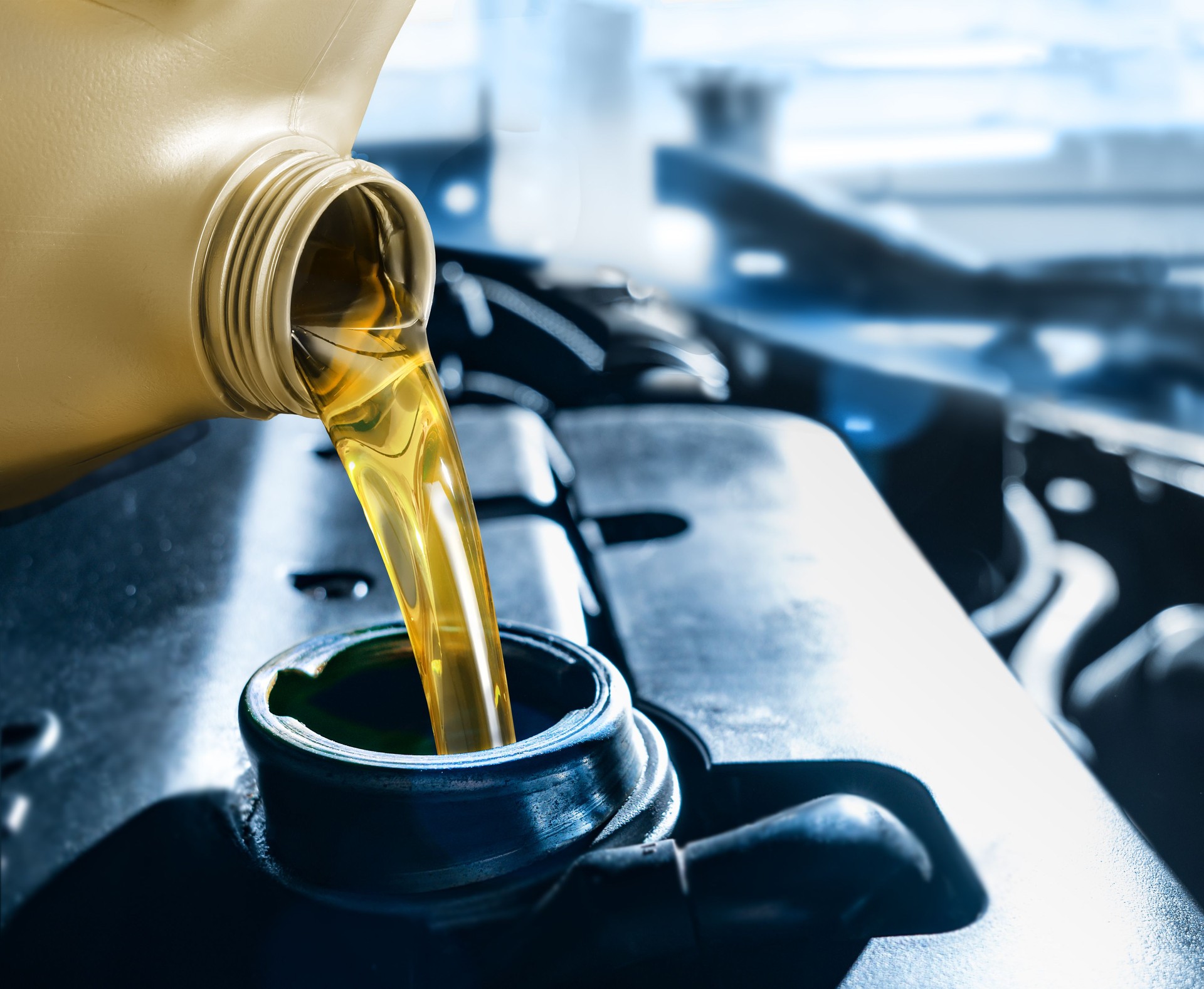 Pouring motor oil into the car engine
